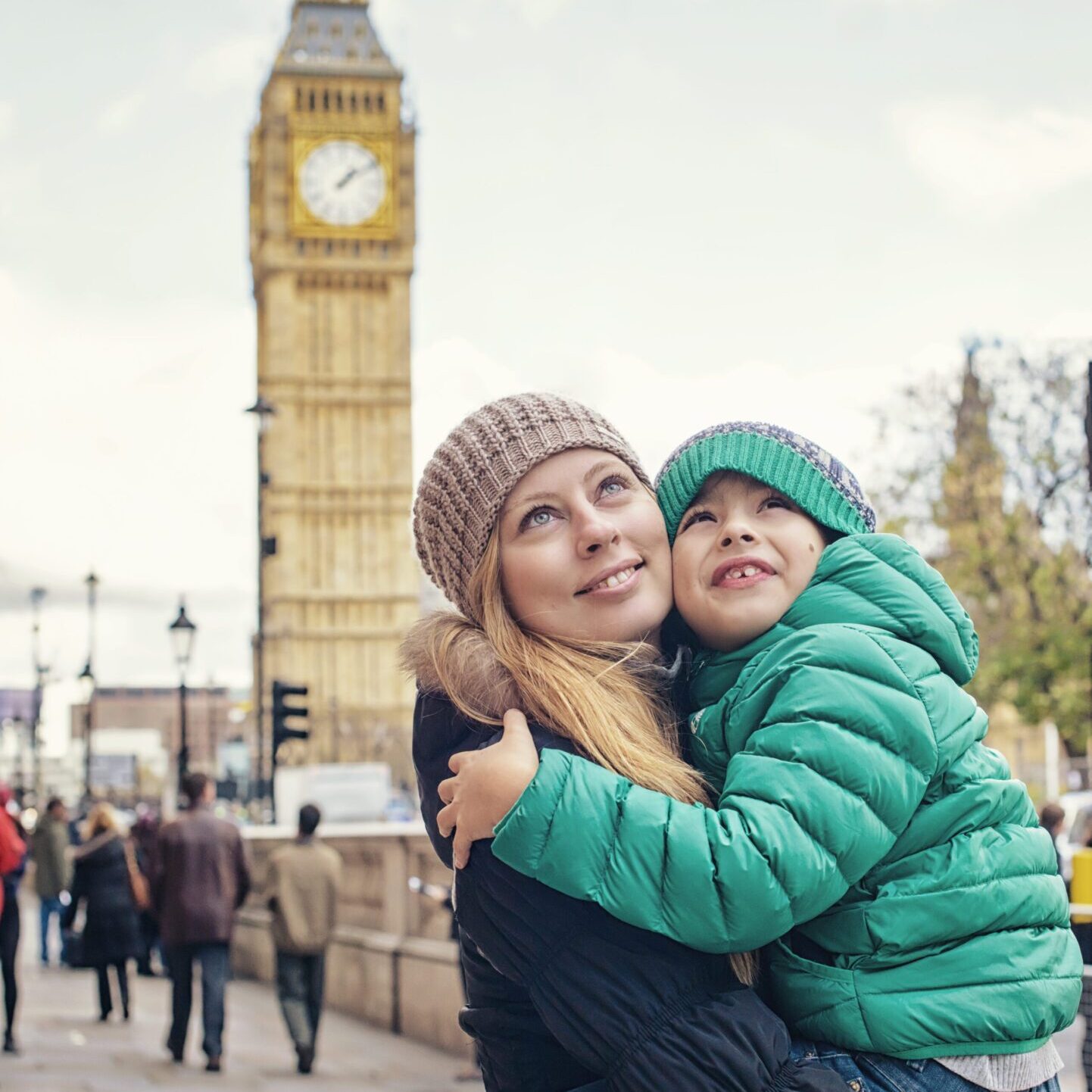 Mother and child hugging near Big Ben in London.